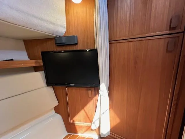 Yellow Jacket Yacht Photos Pics Interior of 2020 Ranger Tugs R-31 CB with TV and wooden cabinetry.