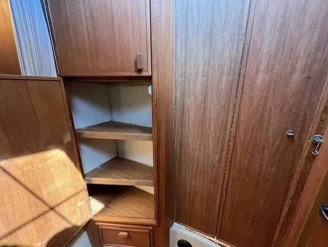Yellow Jacket Yacht Photos Pics 2020 Ranger Tugs R-31 CB interior with wooden cabinetry and corner shelves.
