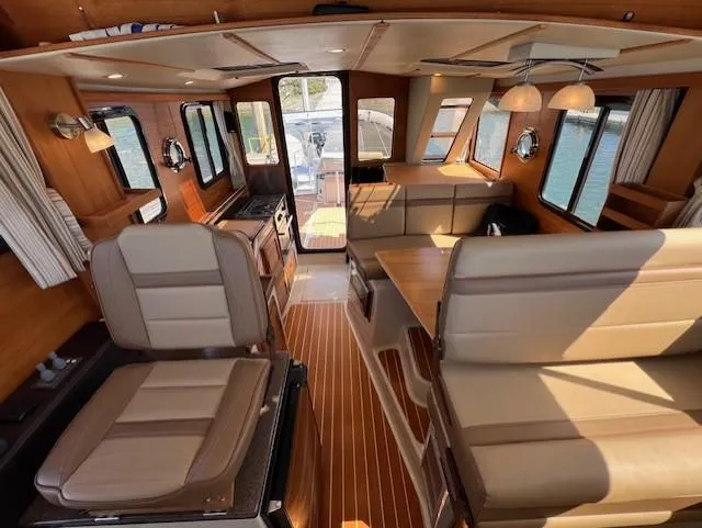 Yellow Jacket Yacht Photos Pics Interior of 2020 Ranger Tugs R-31 CB, featuring elegant seating and wood finishes.