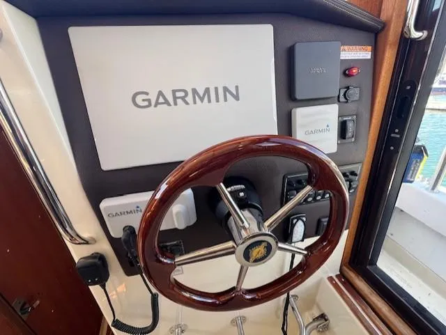 Yellow Jacket Yacht Photos Pics 2020 Ranger Tugs R-31 CB helm with Garmin navigation system and wooden steering wheel.