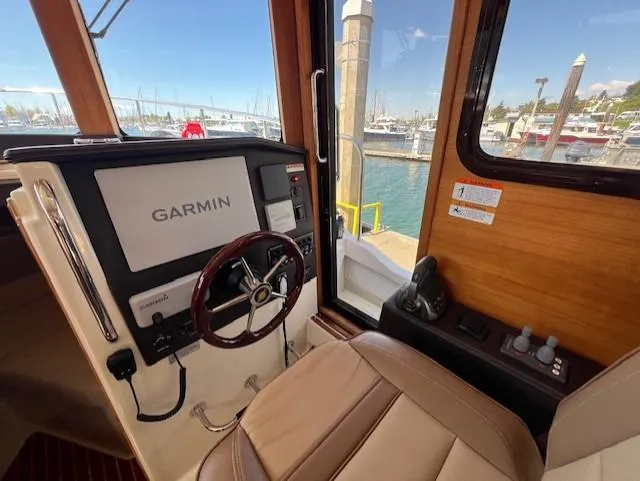 Yellow Jacket Yacht Photos Pics 2020 Ranger Tugs R-31 CB helm with Garmin navigation, docked at marina.
