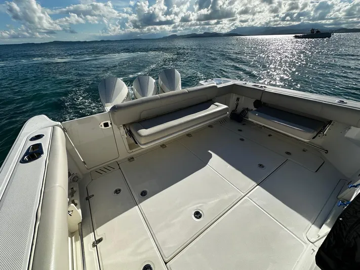  Yacht Photos Pics 2022 Boston Whaler 345 Conquest boat deck with ocean view and clear skies.