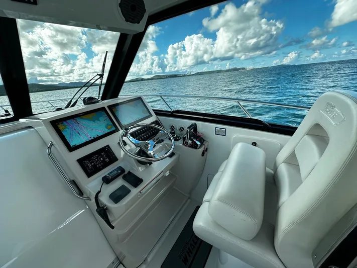  Yacht Photos Pics 2022 Boston Whaler 345 Conquest helm with ocean view and navigation screens.