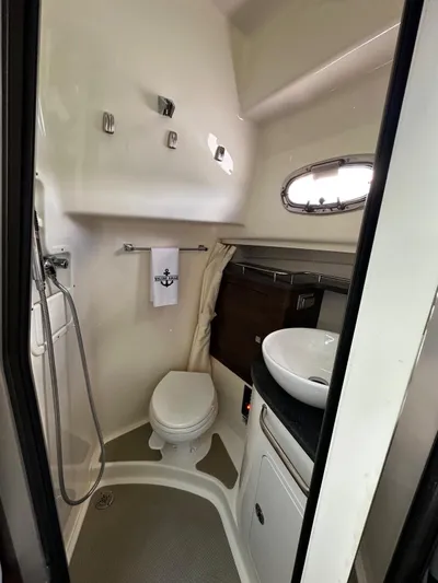  Yacht Photos Pics 2022 Boston Whaler 345 Conquest bathroom with modern fixtures and compact design.