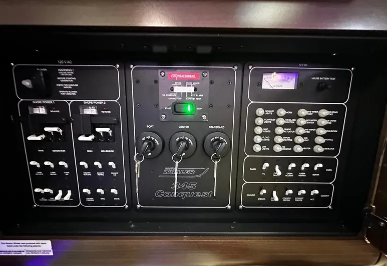  Yacht Photos Pics Control panel of 2022 Boston Whaler 345 Conquest boat with switches and indicators.