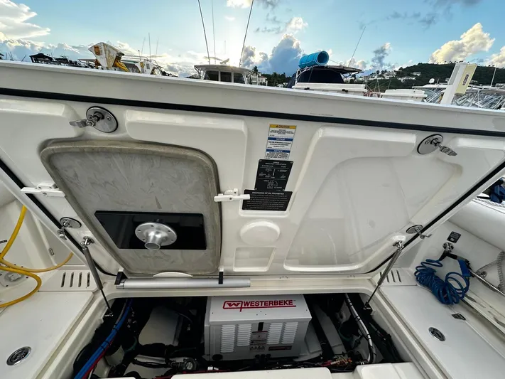  Yacht Photos Pics Boston Whaler 345 Conquest 2022 engine compartment with Westerbeke generator, open hatch view.
