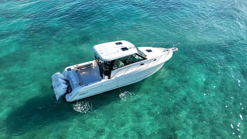  Yacht Photos Pics Boston Whaler 345 Conquest 2022 cruising on clear turquoise waters.