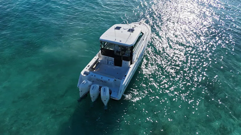  Yacht Photos Pics Boston Whaler 345 Conquest 2022 cruising on clear turquoise waters.