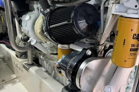 Enticer Yacht Photos Pics Engine components of a 1998 Gamefisherman 34 Express boat, featuring filters and mechanical parts.