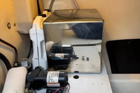 Enticer Yacht Photos Pics 1998 Gamefisherman 34 Express engine room with equipment and reflective surfaces.