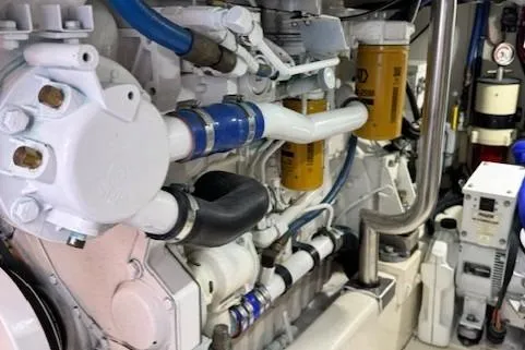 Enticer Yacht Photos Pics Engine room of 1998 Gamefisherman 34 Express with visible pipes and filters.