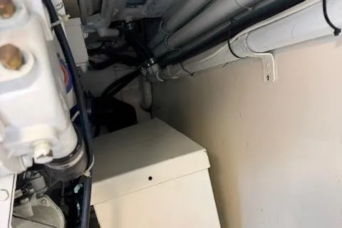 Enticer Yacht Photos Pics Engine room of 1998 Gamefisherman 34 Express, showing pipes and mechanical components.