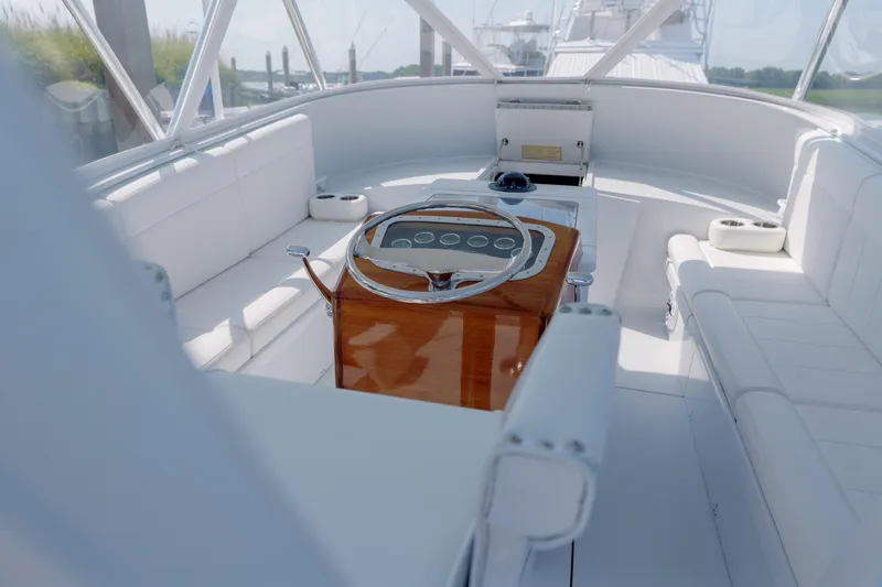Enticer Yacht Photos Pics Luxurious 1998 Gamefisherman Enticer boat interior with white seating and polished wood helm.