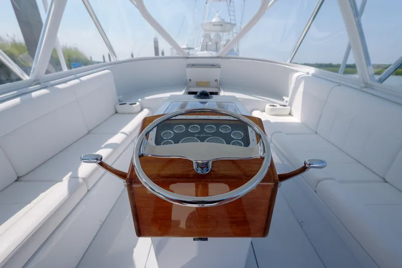 Enticer Yacht Photos Pics 1998 Gamefisherman Enticer boat interior with wooden steering wheel and white seating.