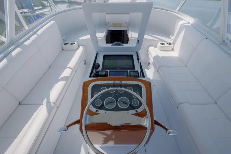 Enticer Yacht Photos Pics 1998 Gamefisherman Enticer boat interior with white seating and wooden steering console.