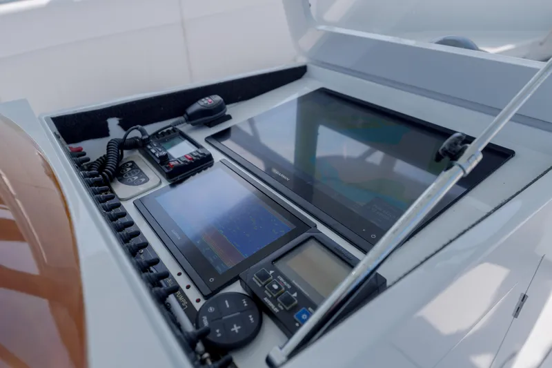 Enticer Yacht Photos Pics Control panel of a 1998 Gamefisherman Enticer boat with navigation screens and communication devices.