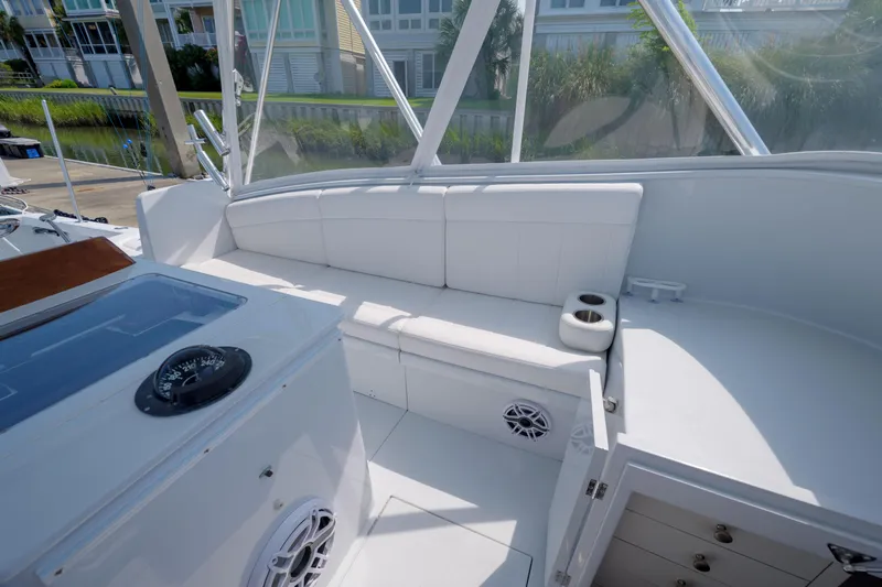 Enticer Yacht Photos Pics 1998 Gamefisherman Enticer boat interior with white seating, cup holders, and compass.