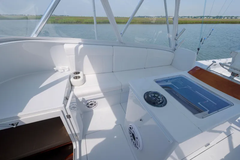 Enticer Yacht Photos Pics 1998 Gamefisherman Enticer boat interior with white seating and fishing equipment.