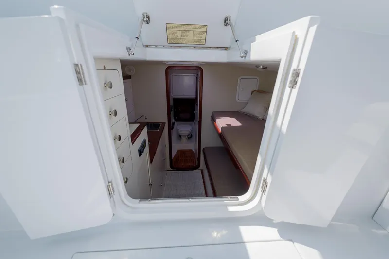 Enticer Yacht Photos Pics 1998 Gamefisherman Enticer cabin interior with bed, storage, and compact bathroom.