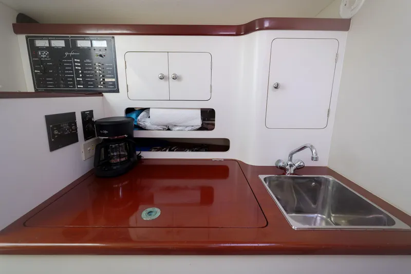 Enticer Yacht Photos Pics 1998 Gamefisherman Enticer yacht galley with sink, coffee maker, and control panel.