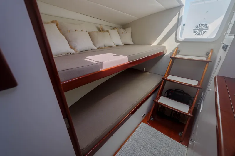Enticer Yacht Photos Pics Cozy cabin interior of 1998 Gamefisherman Enticer with bunk beds and wooden ladder.
