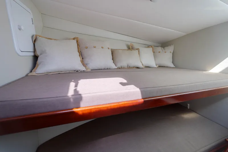 Enticer Yacht Photos Pics Cozy cabin interior of 1998 Gamefisherman Enticer with cushions and wooden trim.