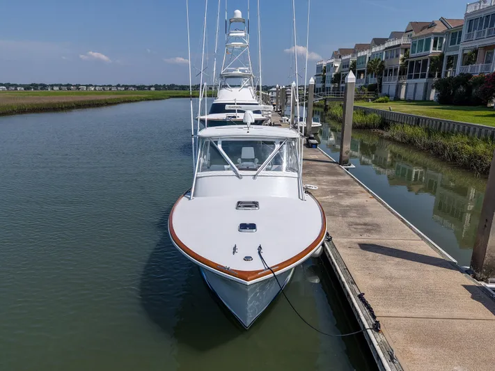 Enticer Yacht Photos Pics 1998 Gamefisherman Enticer yacht docked in a serene marina setting.