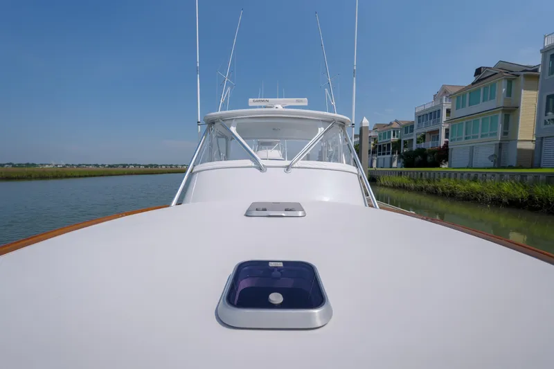 Enticer Yacht Photos Pics 1998 Gamefisherman Enticer boat on calm water near waterfront homes.