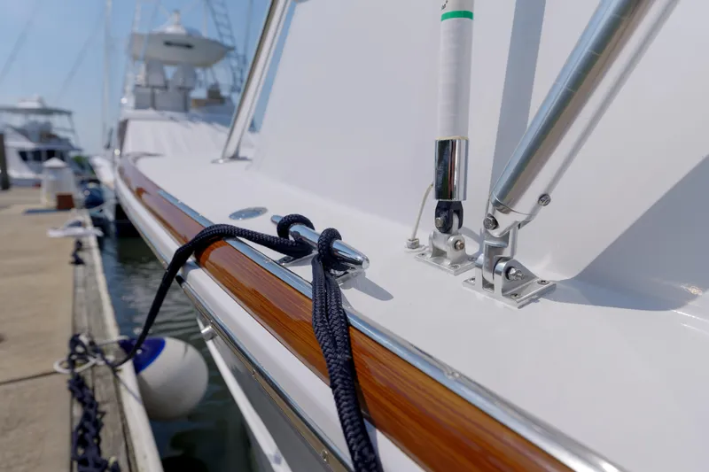 Enticer Yacht Photos Pics Close-up of 1998 Gamefisherman Enticer boat docked, showcasing polished wood and metal details.