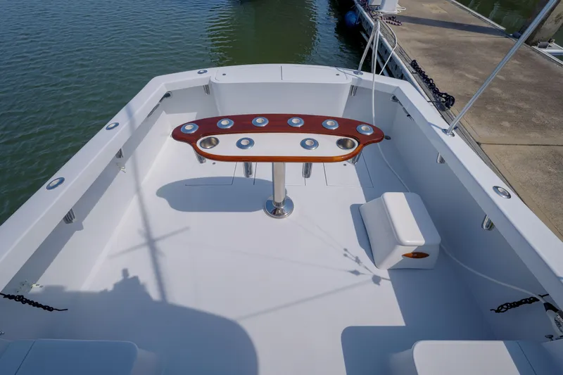 Enticer Yacht Photos Pics 1998 Gamefisherman Enticer boat deck with rod holders and seating, docked at marina.