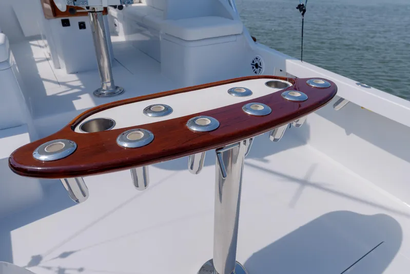 Enticer Yacht Photos Pics Fishing rod holders on a 1998 Gamefisherman Enticer boat deck, with ocean in the background.