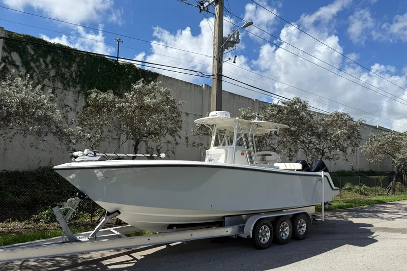  Yacht Photos Pics 2020 SeaVee 290B boat on trailer, parked outdoors under a blue sky.