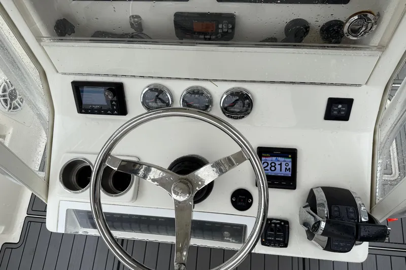  Yacht Photos Pics 2020 SeaVee 290B boat dashboard with steering wheel, gauges, and navigation controls.