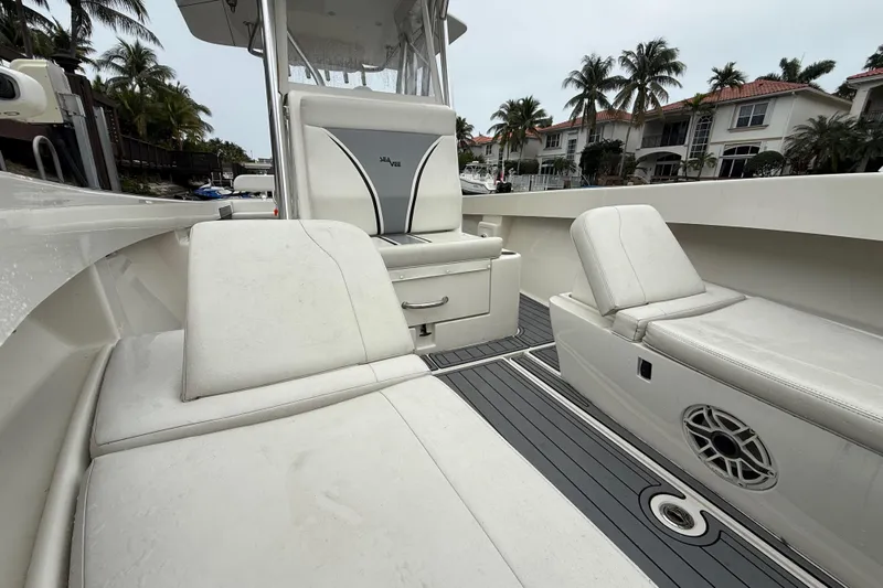  Yacht Photos Pics 2020 SeaVee 290B boat interior with white seating and palm trees in the background.