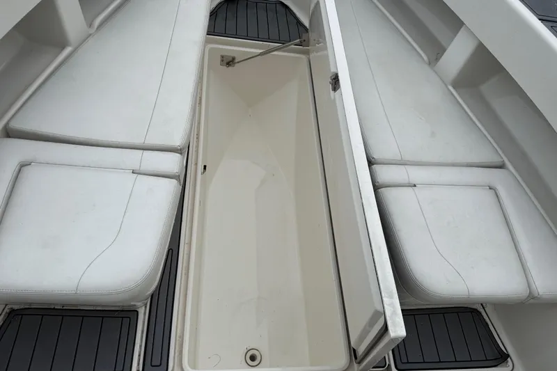  Yacht Photos Pics 2020 SeaVee 290B boat with open storage compartment and cushioned seating.