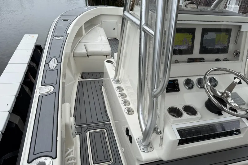  Yacht Photos Pics 2020 SeaVee 290B boat interior with modern dashboard and seating, docked by the water.