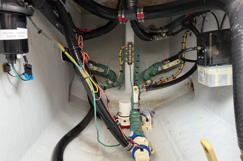  Yacht Photos Pics Engine compartment of a 2020 SeaVee 290B boat, showcasing wiring and plumbing systems.