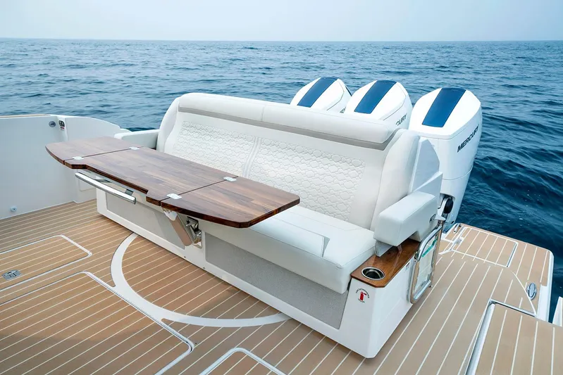  Yacht Photos Pics Manufacturer Provided Image: 2025 Tiara Yachts 48 LE luxury seating with wooden table on open sea.