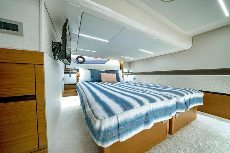  Yacht Photos Pics Manufacturer Provided Image: Luxurious cabin interior of 2025 Tiara Yachts 48 LE with striped bedding.