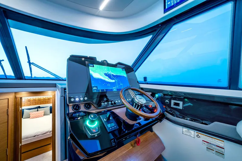  Yacht Photos Pics Manufacturer Provided Image: 2025 Tiara Yachts 48 LE helm with advanced navigation system and luxurious cabin view.