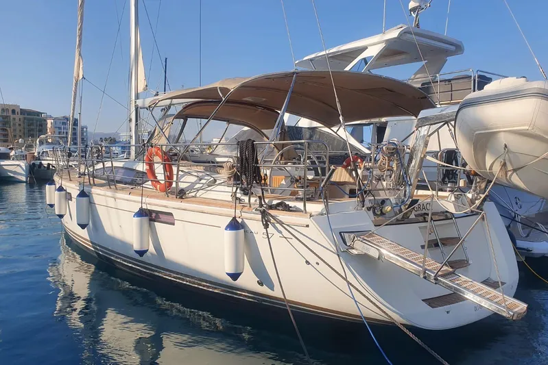  Yacht Photos Pics 2013 Jeanneau 57 yacht docked in marina, featuring sleek design and sunshade canopy.