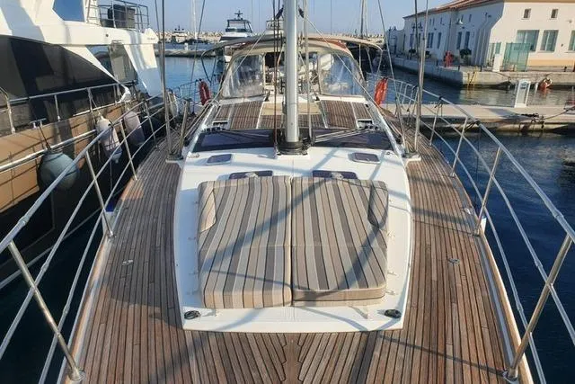  Yacht Photos Pics 2013 Jeanneau 57 yacht with spacious deck and sunbathing area, docked at marina.