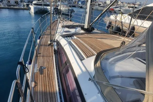  Yacht Photos Pics 2013 Jeanneau 57 sailboat with teak deck, docked in a marina.