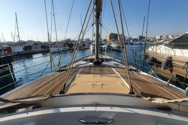  Yacht Photos Pics 2013 Jeanneau 57 yacht docked in a marina, showcasing its elegant deck design.