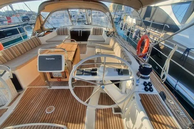  Yacht Photos Pics Cockpit of 2013 Jeanneau 57 yacht with teak decking and navigation equipment.