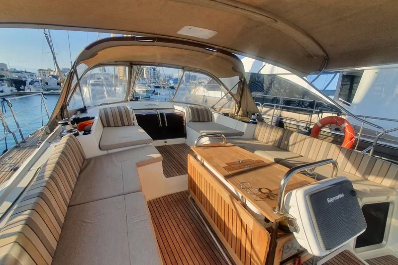  Yacht Photos Pics Luxurious 2013 Jeanneau 57 yacht cockpit with elegant seating and wooden table.