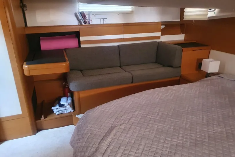  Yacht Photos Pics Interior of 2013 Jeanneau 57 yacht with cozy seating and bed.
