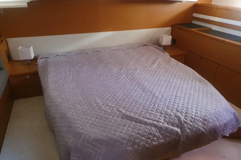  Yacht Photos Pics Luxurious bedroom interior of 2013 Jeanneau 57 yacht with quilted bedspread.