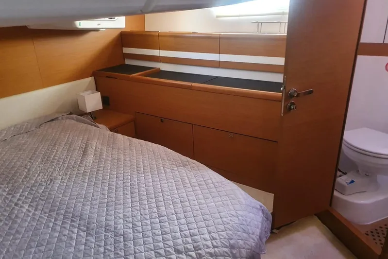  Yacht Photos Pics Cozy cabin interior of 2013 Jeanneau 57 yacht with bed and bathroom.