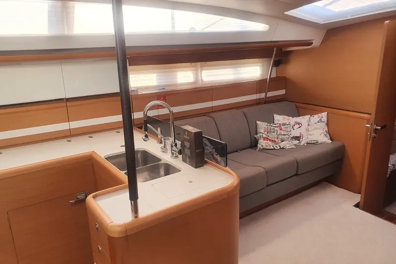  Yacht Photos Pics Interior of 2013 Jeanneau 57 yacht with modern kitchen and cozy seating area.